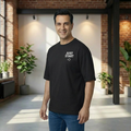 Man wearing a black t-shirt with 'JUST START' text in a modern indoor setting