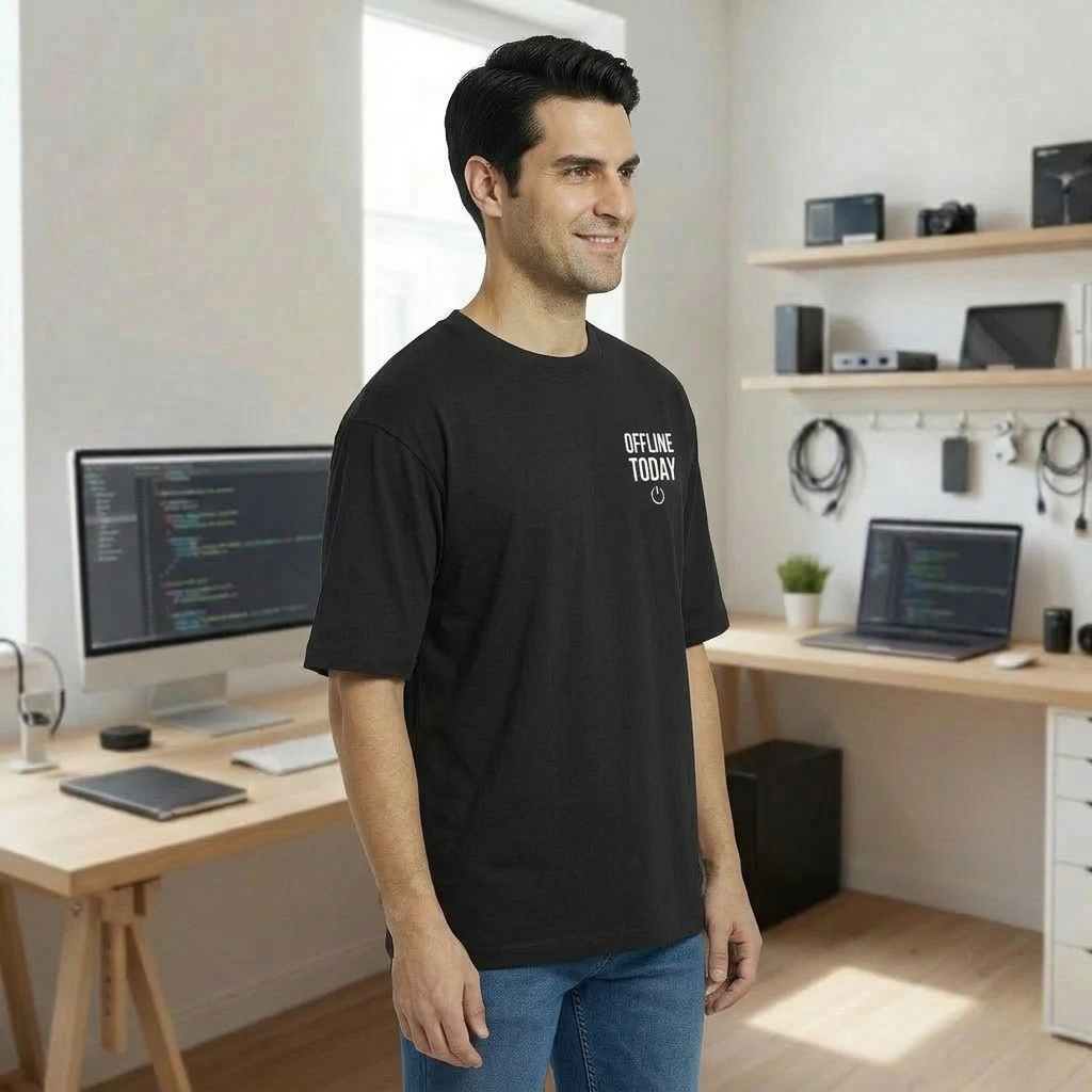 Man wearing a black oversized t-shirt with 'Offline Today' text in a home office setting.