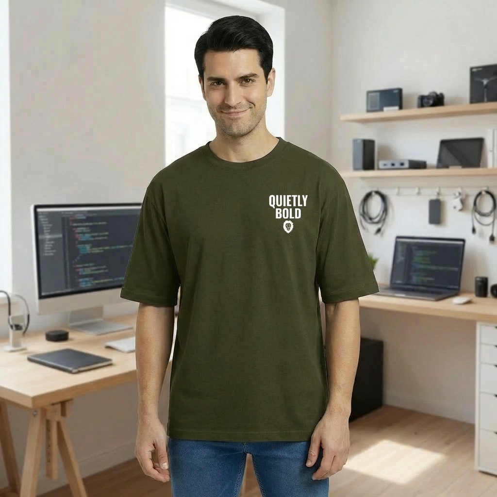 Man wearing a green t-shirt with a logo in a home office setting