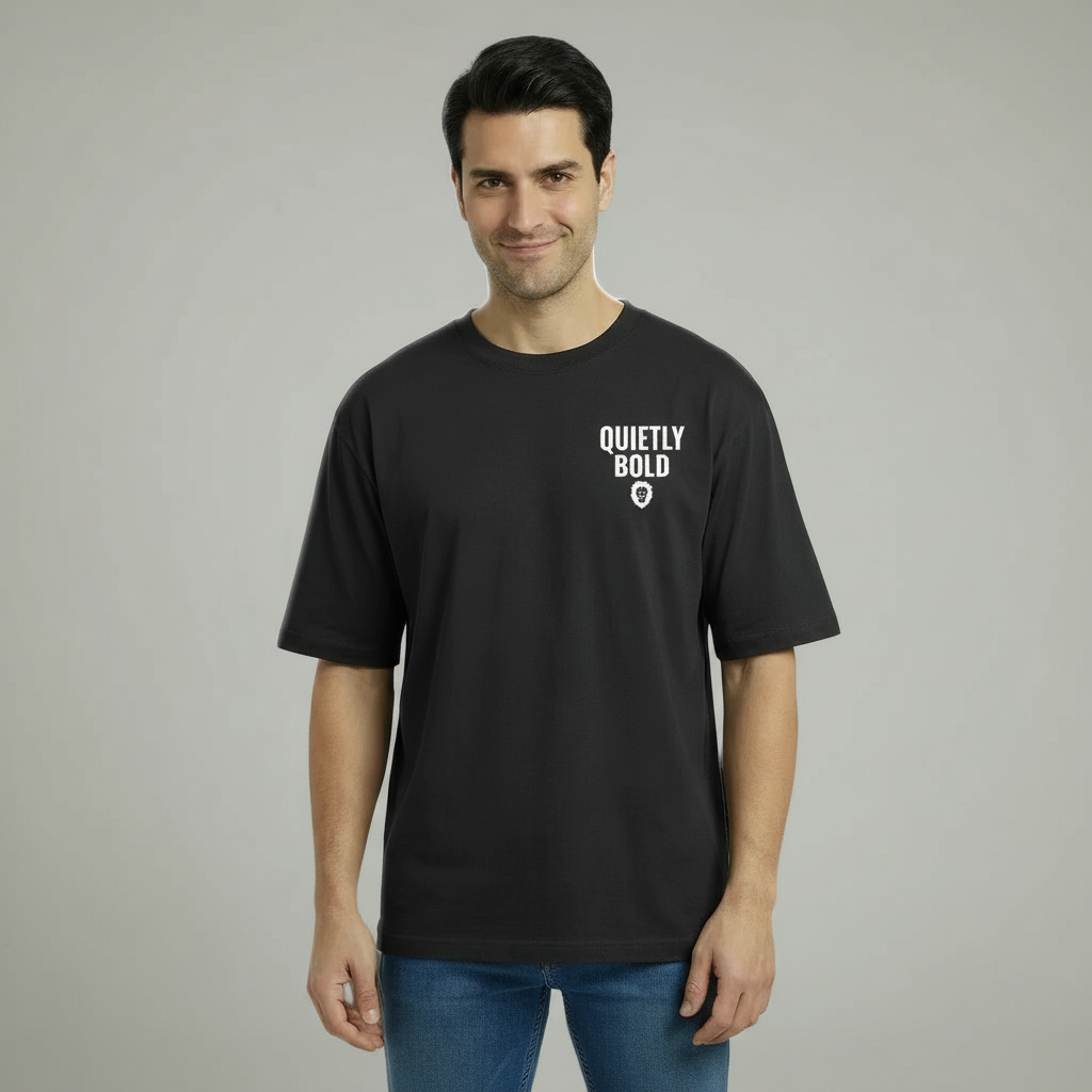 Man wearing a black t-shirt with 'Quietly Bold' text on a gray background