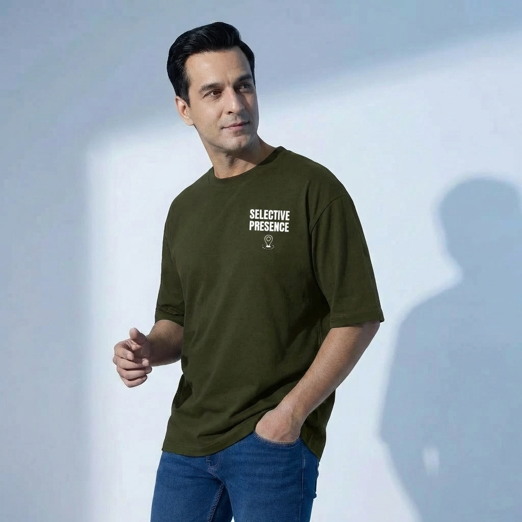 Man wearing a green t-shirt with 'SELECTIVE PRESENCE' text on a light gray background