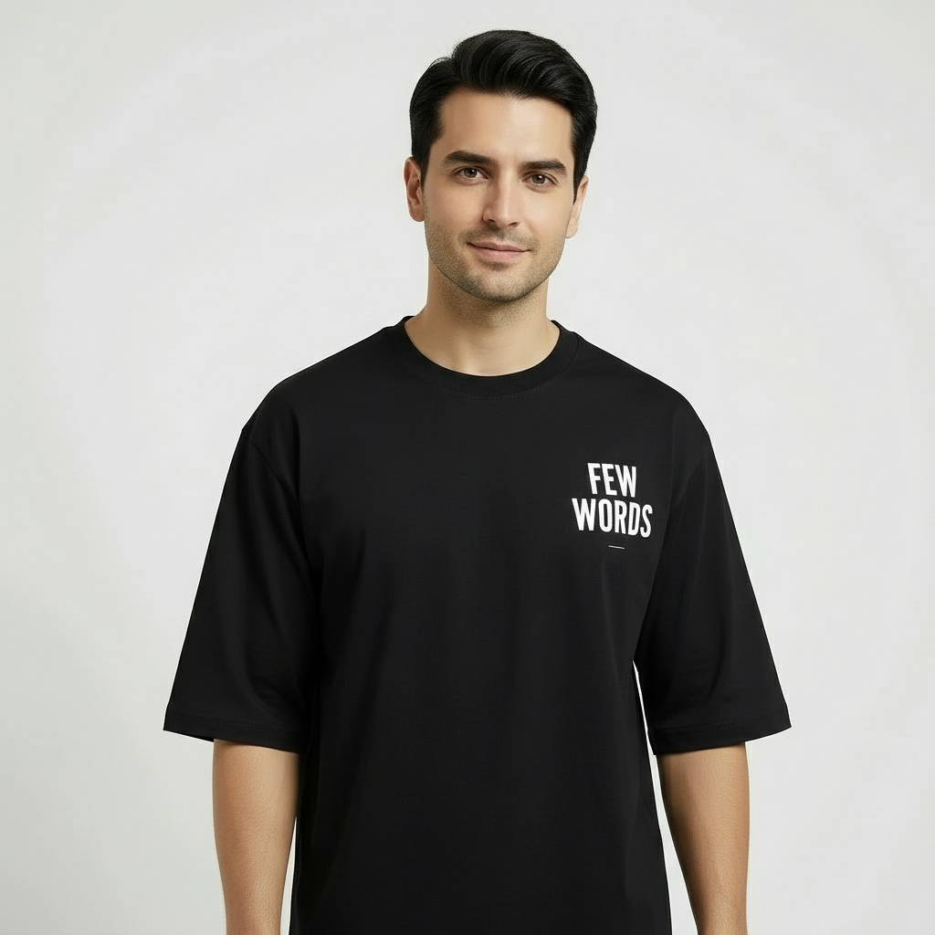 Man wearing a black t-shirt with 'FEW WORDS' text on a plain background