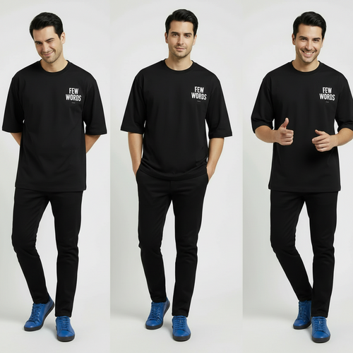 Man wearing a black  oversized t-shirt with 'FEW WORDS' text, posing against a white background.